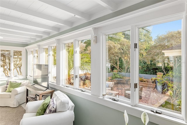 sunroom / solarium featuring beam ceiling and a wealth of natural light