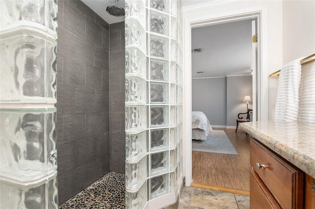 bathroom with vanity and a tile shower