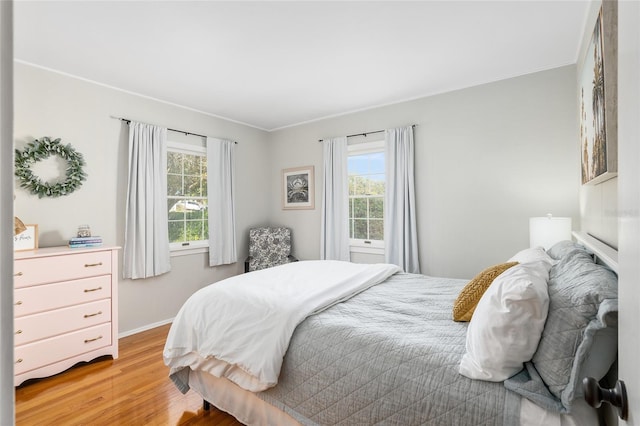 bedroom featuring hardwood / wood-style flooring and ornamental molding