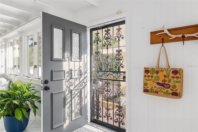 doorway featuring beamed ceiling