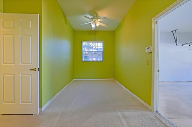 spare room with light carpet and ceiling fan