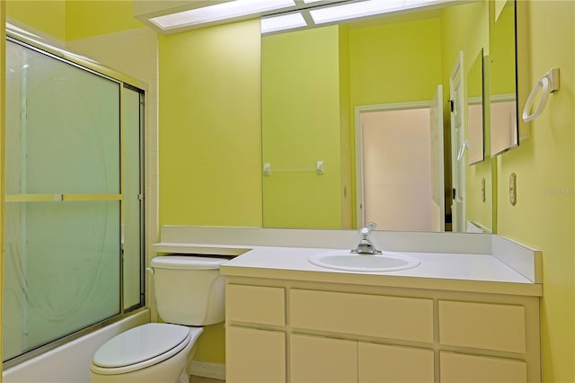 full bathroom with vanity, enclosed tub / shower combo, and toilet