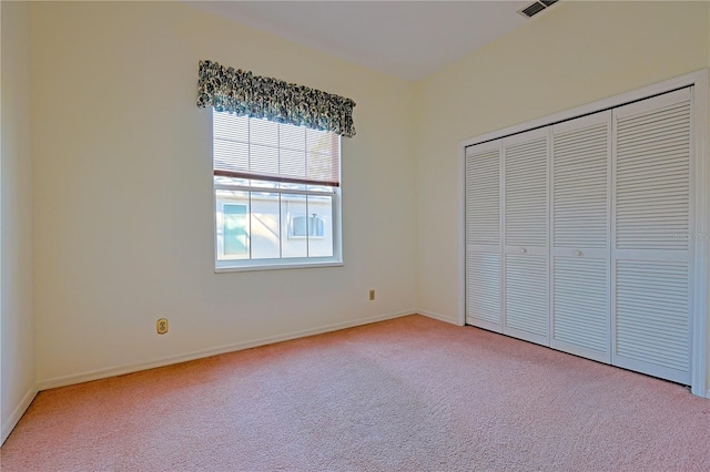 unfurnished bedroom featuring multiple windows, a closet, and carpet