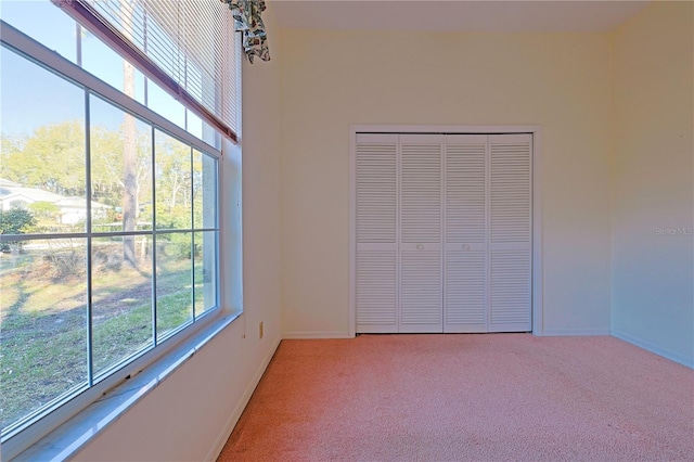 unfurnished bedroom featuring carpet floors and a closet