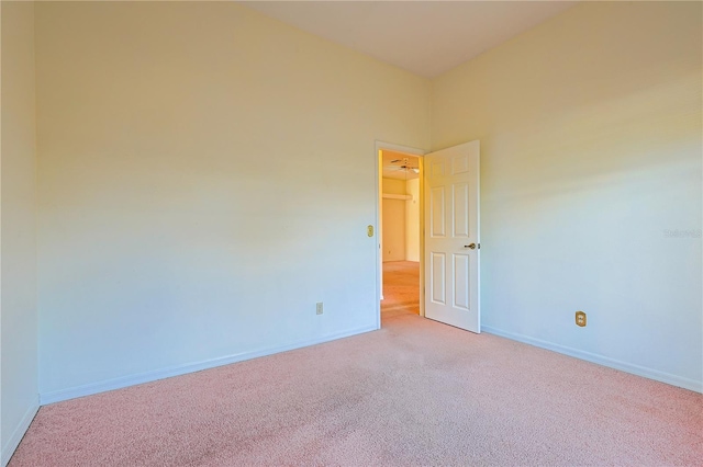 unfurnished room featuring light colored carpet