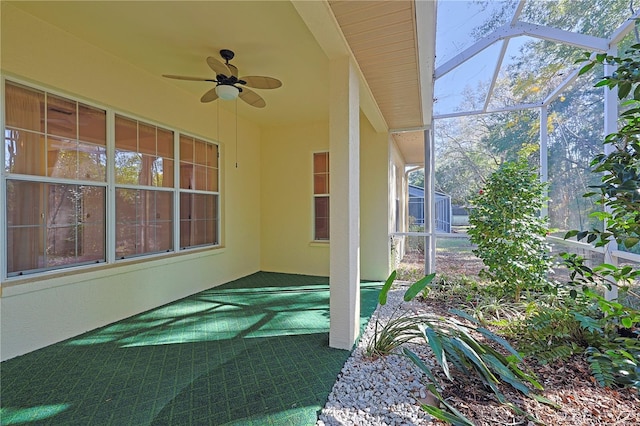 exterior space with ceiling fan and glass enclosure