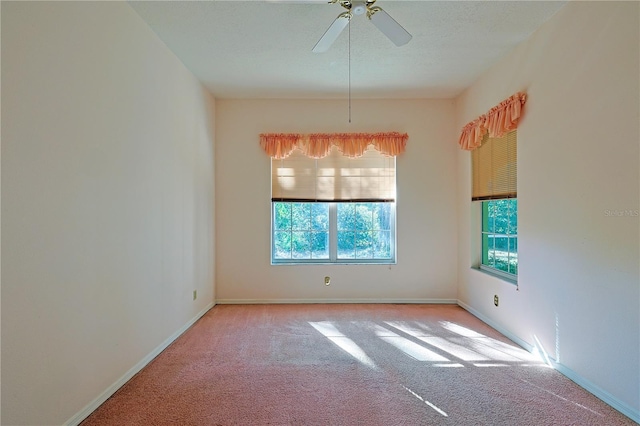 carpeted empty room featuring a textured ceiling and ceiling fan