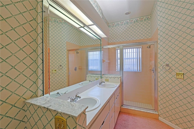 bathroom featuring vanity and a shower with door