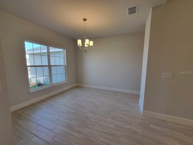 empty room with a chandelier