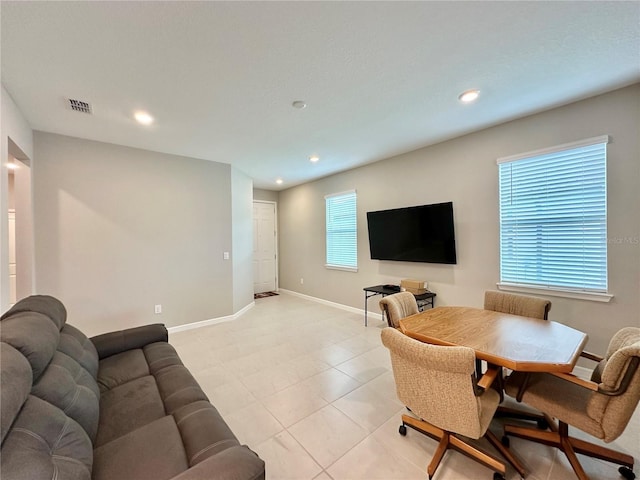 living room with a healthy amount of sunlight and light tile patterned floors