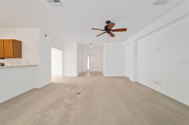 unfurnished living room with light carpet and ceiling fan