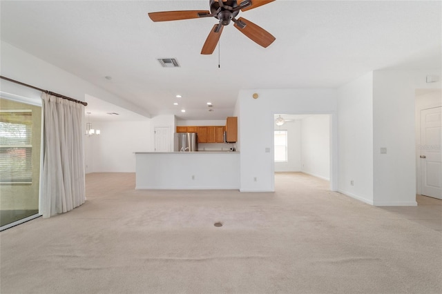 unfurnished living room with light carpet and ceiling fan