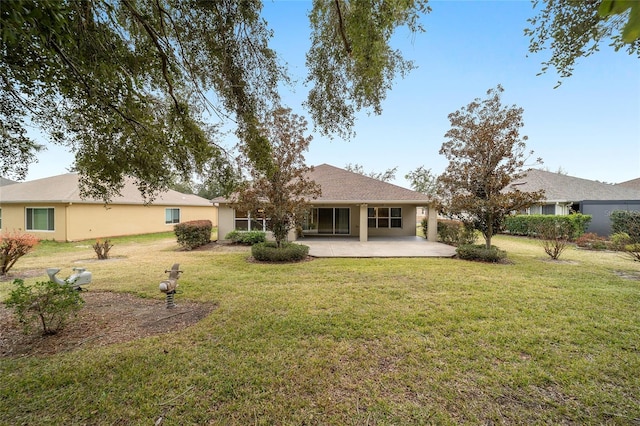 back of house with a yard and a patio