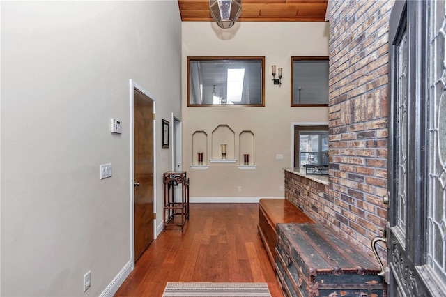 foyer entrance featuring hardwood / wood-style floors, wood ceiling, and a wealth of natural light