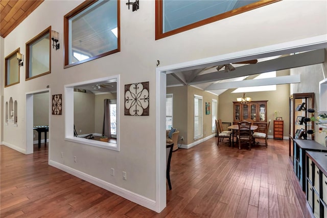 hall featuring hardwood / wood-style flooring, lofted ceiling, wood ceiling, and a chandelier