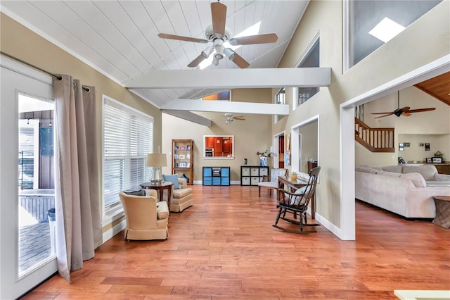 sitting room featuring ceiling fan, wood-type flooring, lofted ceiling with beams, and wooden ceiling