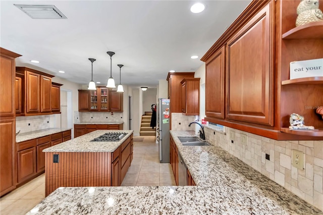 kitchen featuring decorative light fixtures, sink, decorative backsplash, and stainless steel appliances