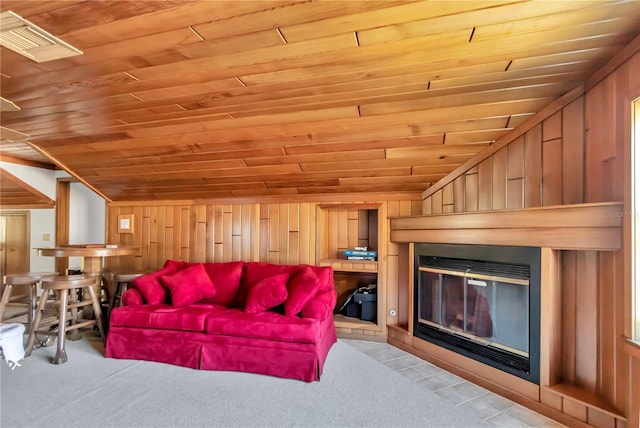 living room featuring vaulted ceiling, light colored carpet, wooden ceiling, and wood walls