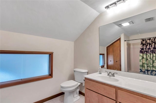 bathroom featuring tile patterned flooring, a shower with shower curtain, vanity, vaulted ceiling, and toilet