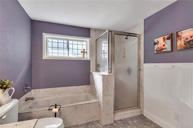 bathroom with toilet and shower with separate bathtub