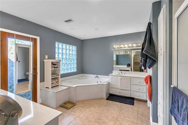 bathroom featuring tile patterned floors, a bathtub, and vanity