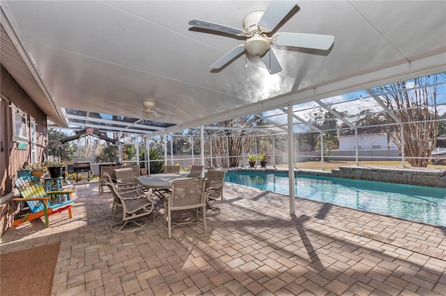 view of swimming pool featuring a lanai, a patio area, and ceiling fan