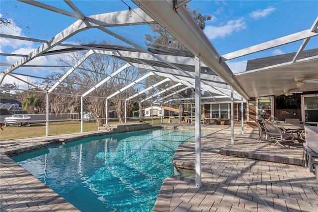 view of swimming pool with a lanai, a patio, and ceiling fan