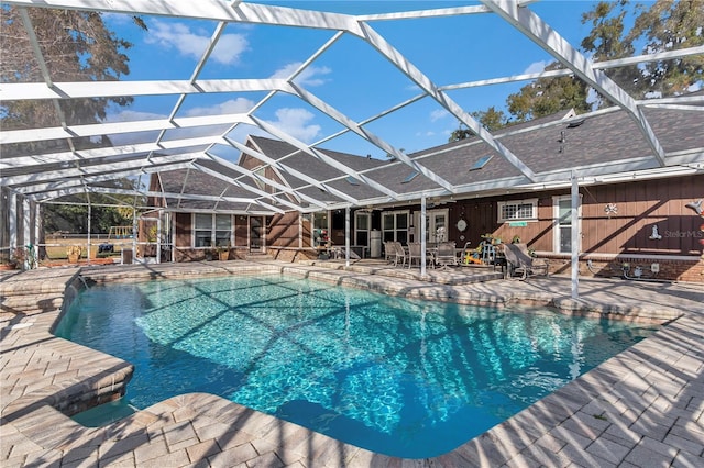 view of pool featuring a patio and glass enclosure