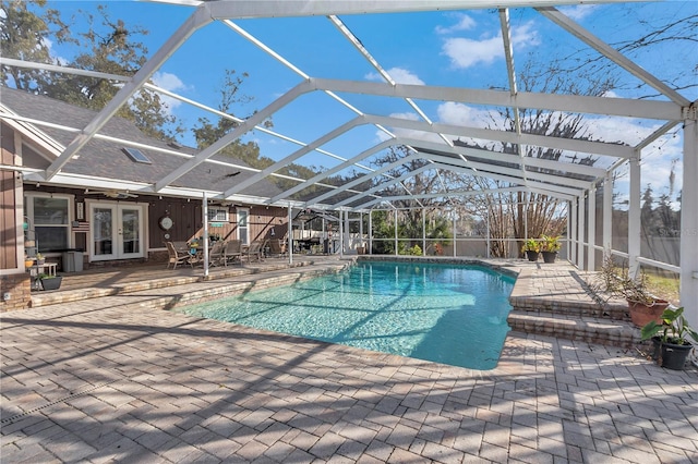 view of pool featuring french doors, a patio, and glass enclosure