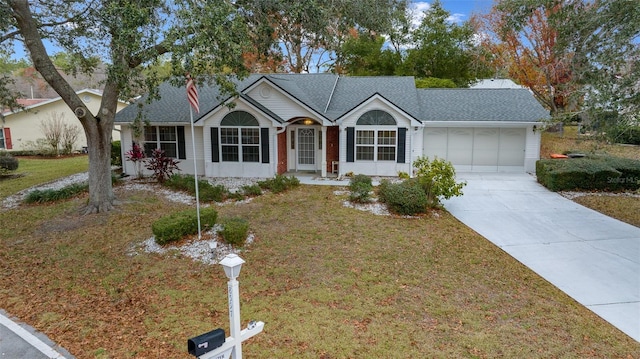 ranch-style house with a garage and a front yard