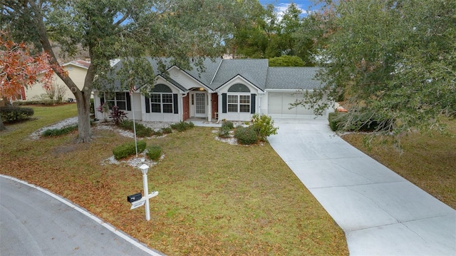 ranch-style house featuring a garage and a front lawn