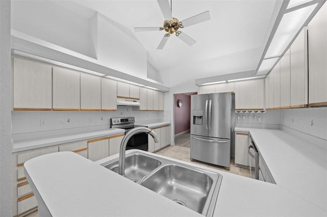 kitchen with appliances with stainless steel finishes, high vaulted ceiling, sink, a kitchen breakfast bar, and ceiling fan