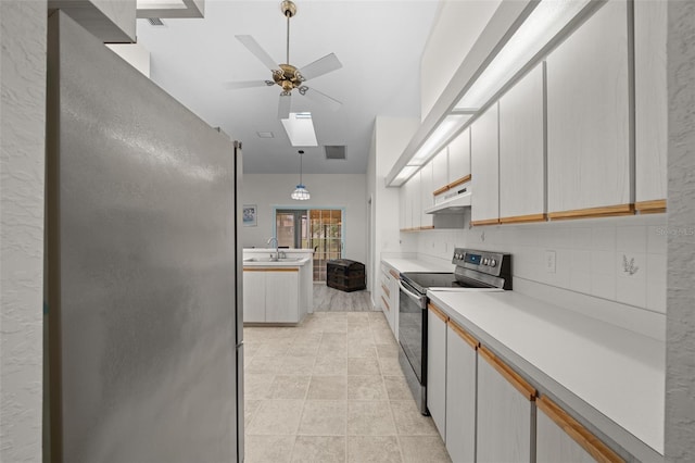 kitchen featuring appliances with stainless steel finishes, pendant lighting, a skylight, white cabinetry, and ceiling fan