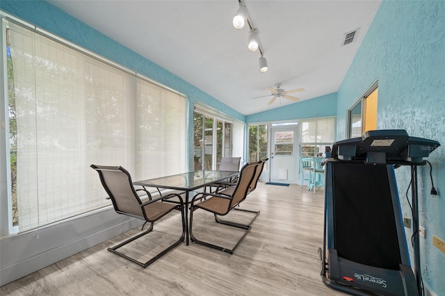 sunroom / solarium featuring ceiling fan and vaulted ceiling