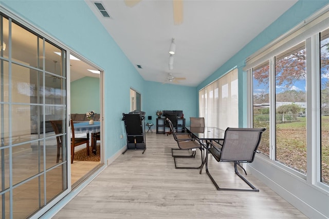 sunroom / solarium with ceiling fan and lofted ceiling