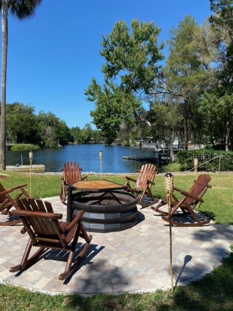 view of patio featuring a water view and an outdoor fire pit