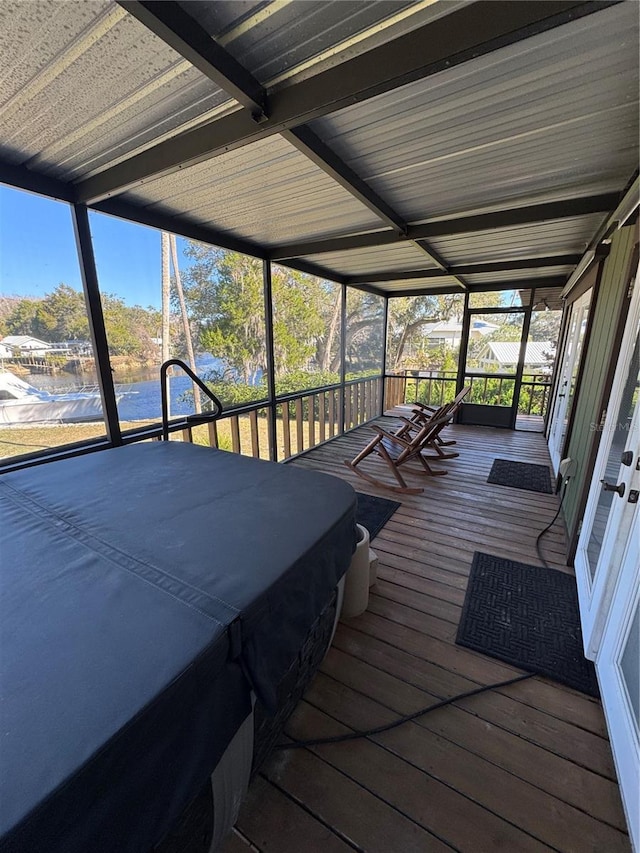 unfurnished sunroom with a water view