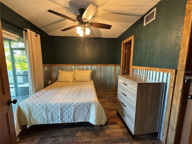 bedroom featuring dark wood-type flooring, access to exterior, and ceiling fan