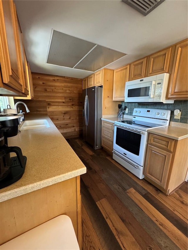 kitchen with white appliances, dark hardwood / wood-style flooring, and sink