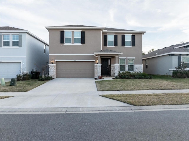 view of front of property with a garage and a front lawn