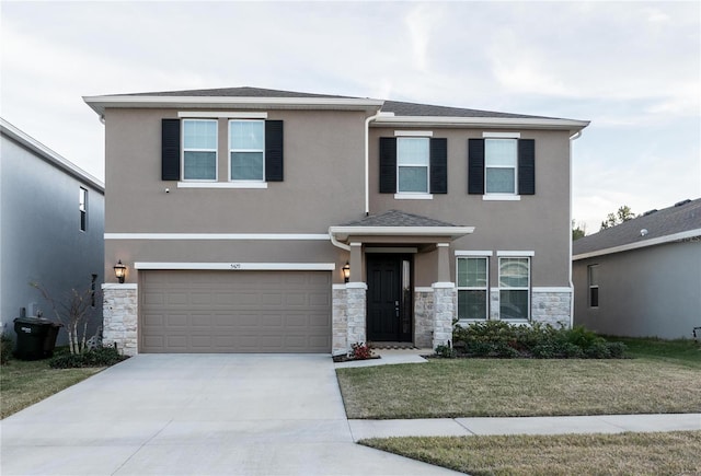 view of front of property with a garage and a front yard