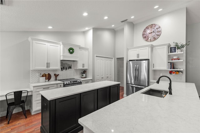 kitchen featuring white cabinetry, sink, decorative backsplash, and stainless steel appliances