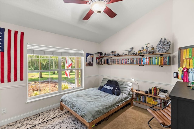 carpeted bedroom with ceiling fan and lofted ceiling