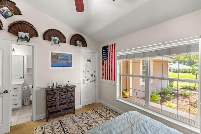 carpeted bedroom featuring ceiling fan, connected bathroom, and vaulted ceiling