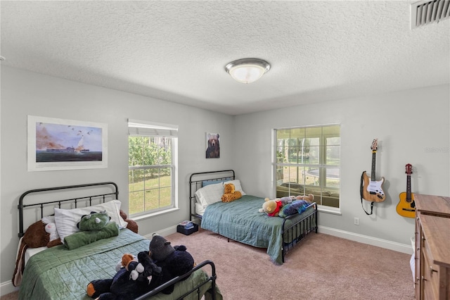 carpeted bedroom featuring a textured ceiling