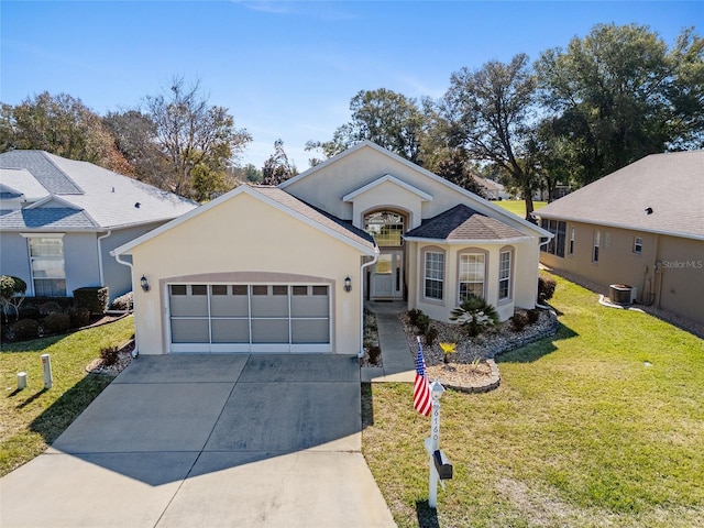 ranch-style home with a garage, a front yard, and central AC unit