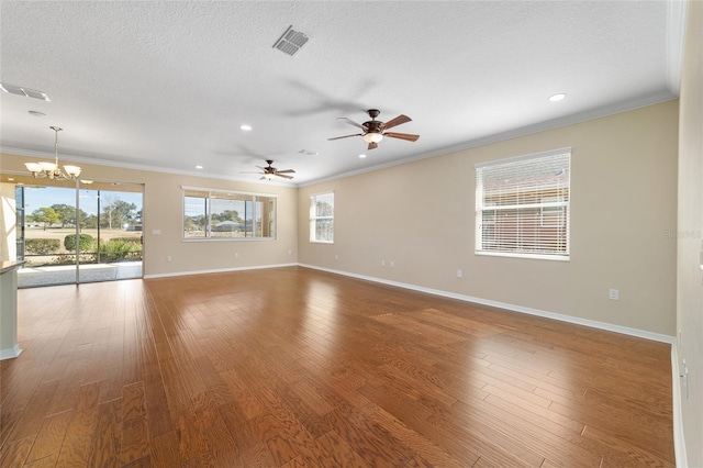 spare room featuring hardwood / wood-style flooring, plenty of natural light, crown molding, and a textured ceiling