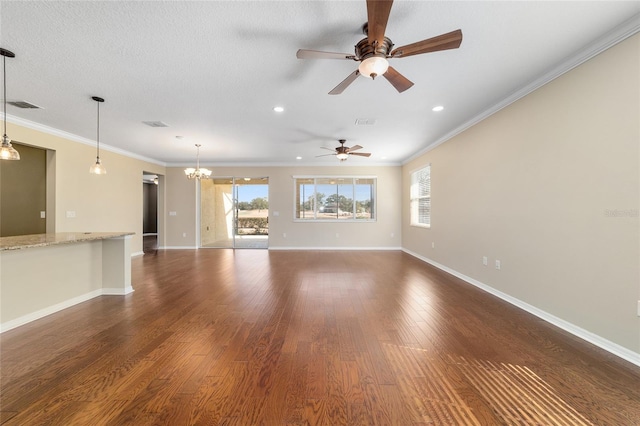 unfurnished living room with dark hardwood / wood-style flooring, crown molding, and a wealth of natural light