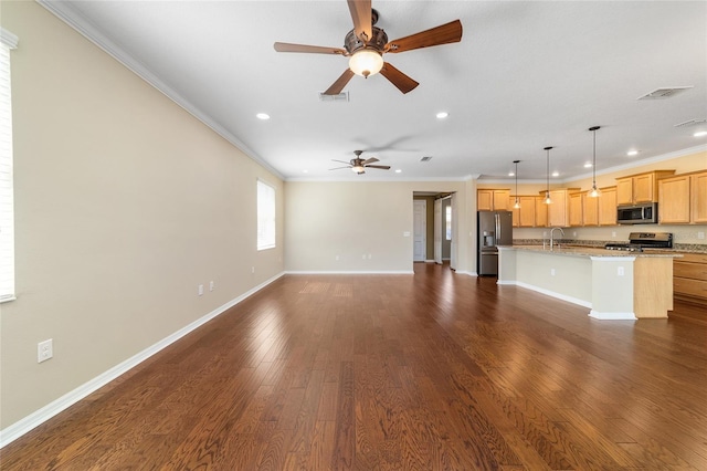 unfurnished living room featuring sink, ornamental molding, dark hardwood / wood-style floors, and ceiling fan