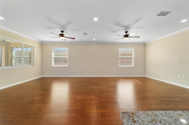 empty room with crown molding, dark wood-type flooring, ceiling fan, and a textured ceiling